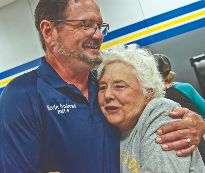 MUCH APPRECIATED: Lipan Fire Department’s Kevin Andrews enjoys a warm embrace from friend and supporter Laura Smith at the Lipan first responder appreciation barbecue.